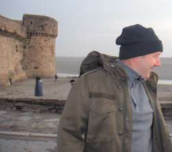 Neil takes care not to get his feet wet as he crosses over to Mont St Michel.