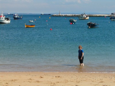 Fiona paddling in the sea at Fishermen's beach, Cascais
