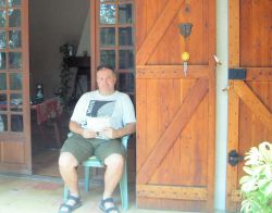 John finds a shady spot on the front porch