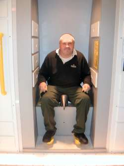 John on a spacecraft toilet at the Edmonton Space and Science museum