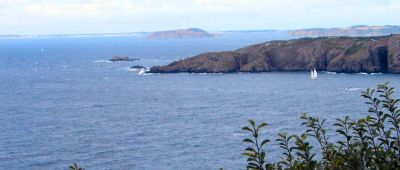 a magnificent view from Sark of Brecqhou island in the foreground and Herm in the distance.