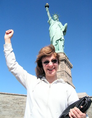Fiona posing at the foot of the Statue of Liberty