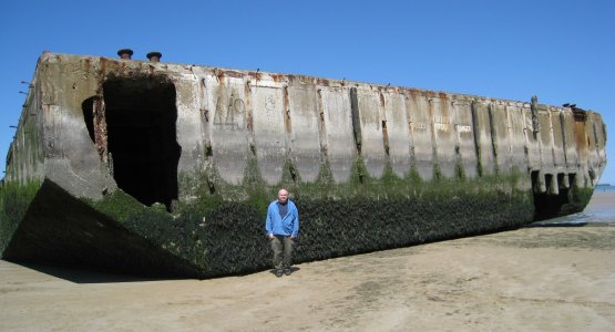 John standing next to a huge concrete remnant of the Mulberry harbour
