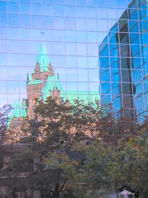 The reflection of Parliament Hill in the windows of the Bank of Canada