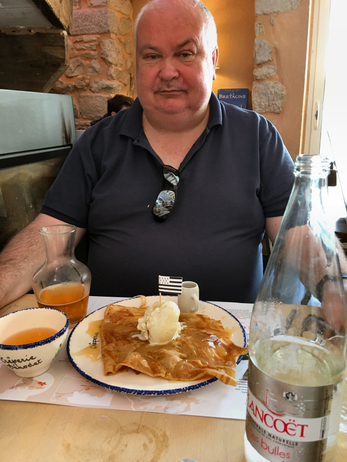 John eating crepes with cider