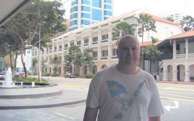 John on his way to the Raffles Hotel at 1 Beach Road