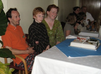 Dave, Ilona and Jonah prepare to cut the cake
