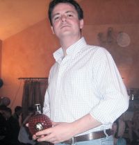 Gareth is proud of winning this fancy bottle of whisky.