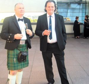 John wearing his kilt drinking champagne with Jim