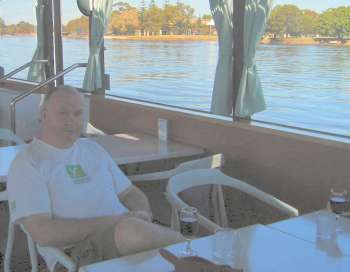 John tastes his first glass of the day